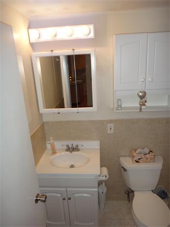 270 Main Street, Unit 2 North Reading, MA 01864 - Photo 5 of 7 a bathroom with a sink and mirror