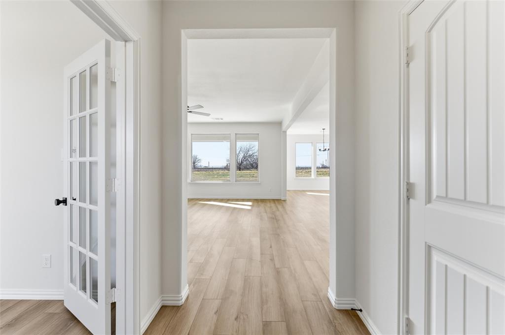 185 Brandywine Trail Rhome, TX 76078 - Photo 11 of 27 Corridor with light wood-style flooring and baseboards