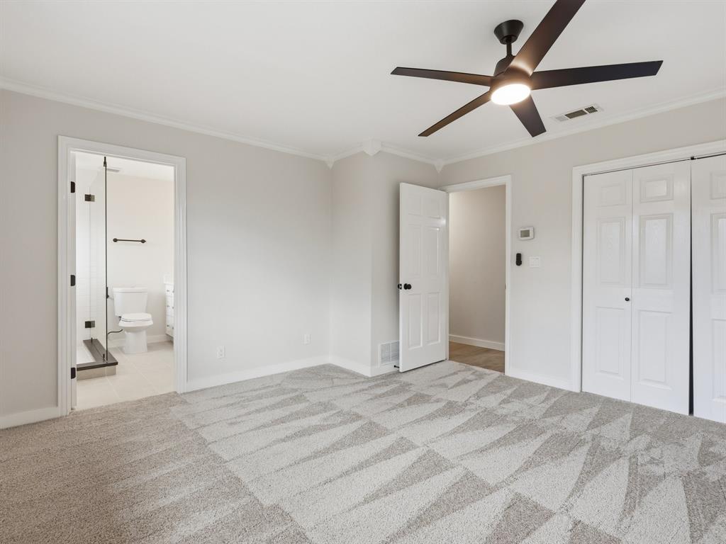 3109 Ridgedale Street Irving, TX 75062 - Photo 11 of 21 Unfurnished bedroom featuring ornamental molding, ceiling fan, light colored carpet, and a closet