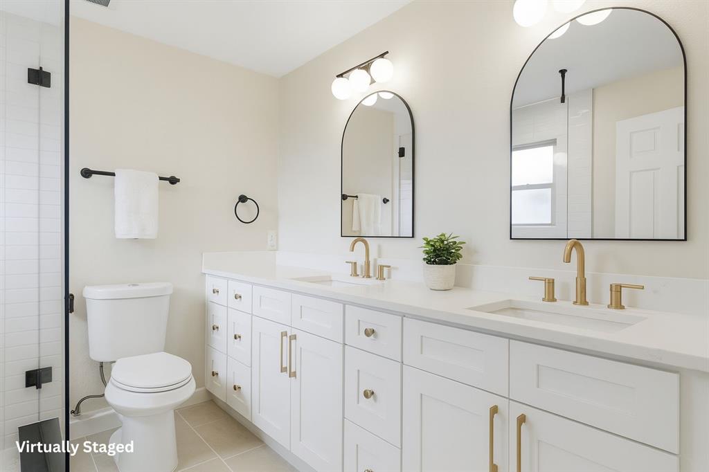 3109 Ridgedale Street Irving, TX 75062 - Photo 12 of 21 Bathroom with double vanity, light tile patterned floors, and tiled shower