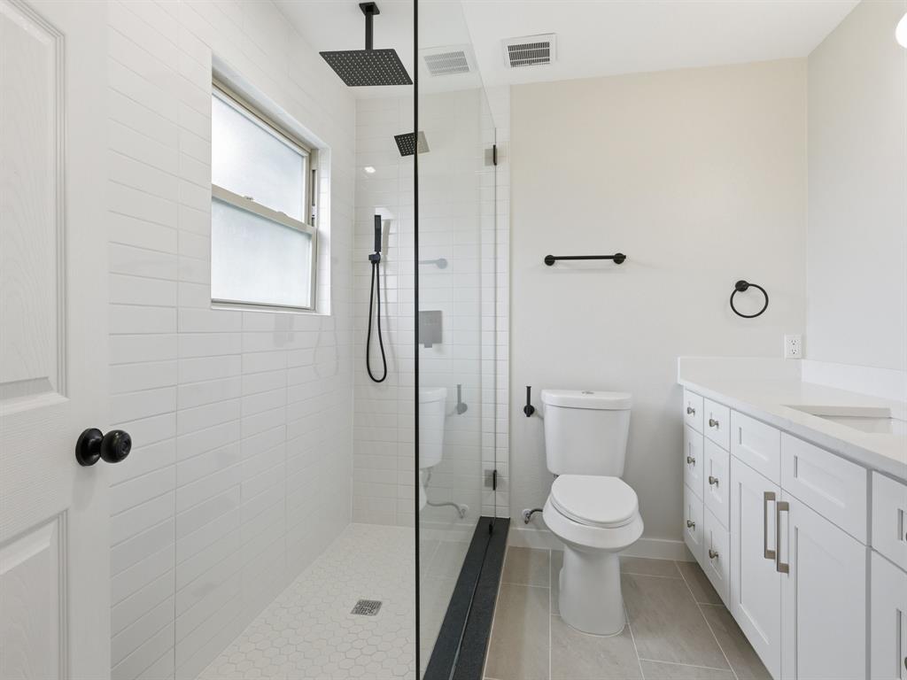 3109 Ridgedale Street Irving, TX 75062 - Photo 13 of 21 Bathroom featuring vanity, walk in shower, and light tile patterned floors