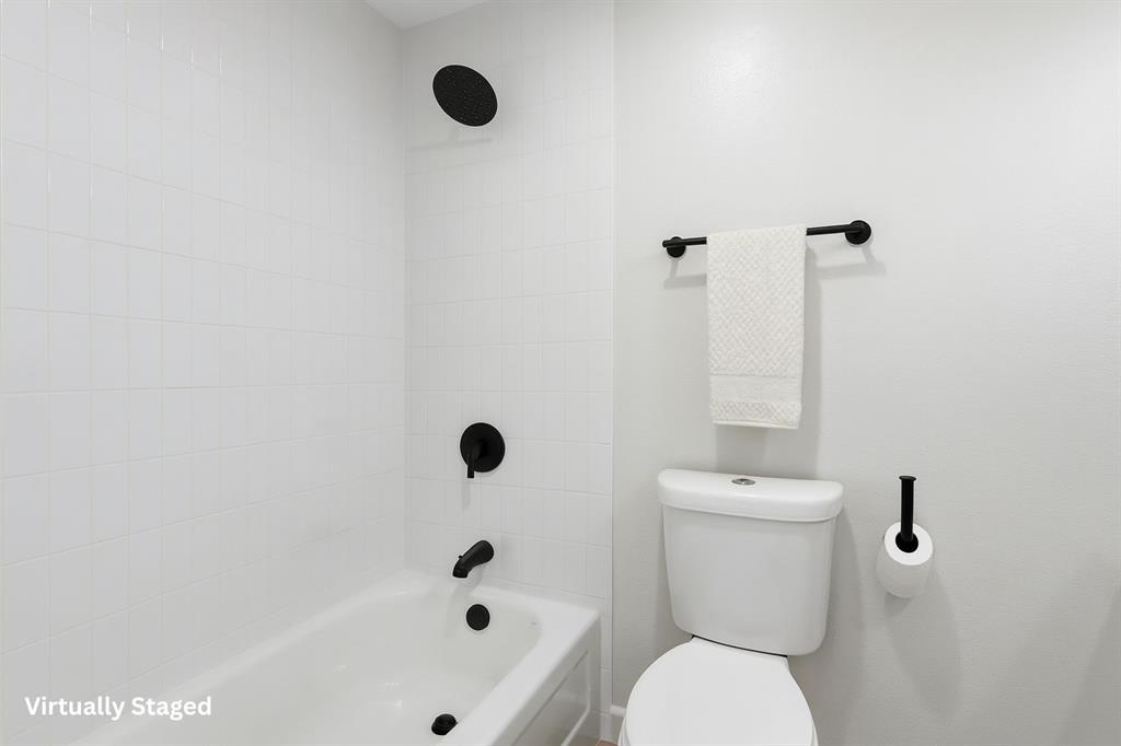 3109 Ridgedale Street Irving, TX 75062 - Photo 17 of 21 Bathroom with washtub / shower combination and toilet
