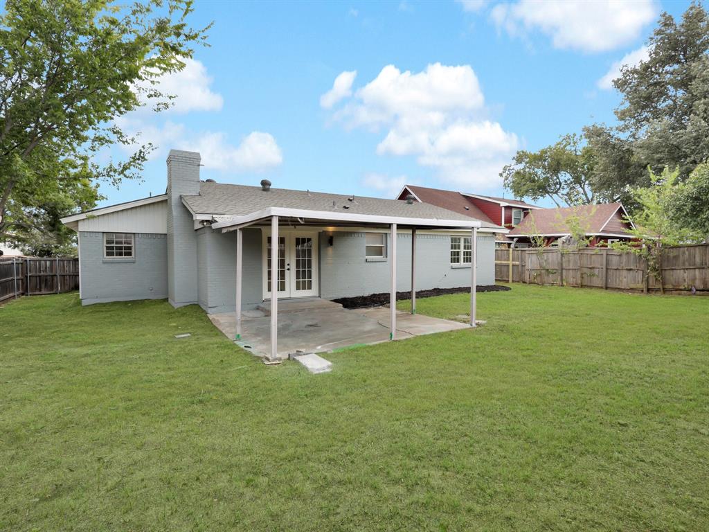 3109 Ridgedale Street Irving, TX 75062 - Photo 20 of 21 Rear view of property featuring a fenced backyard, french doors, a patio, a chimney, and brick siding
