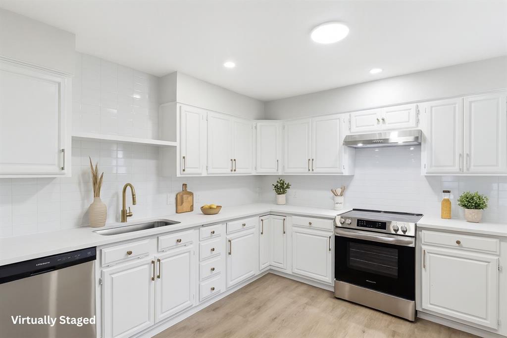 3109 Ridgedale Street Irving, TX 75062 - Photo 7 of 21 Kitchen with appliances with stainless steel finishes, decorative backsplash, white cabinetry, light wood-style floors, and recessed lighting
