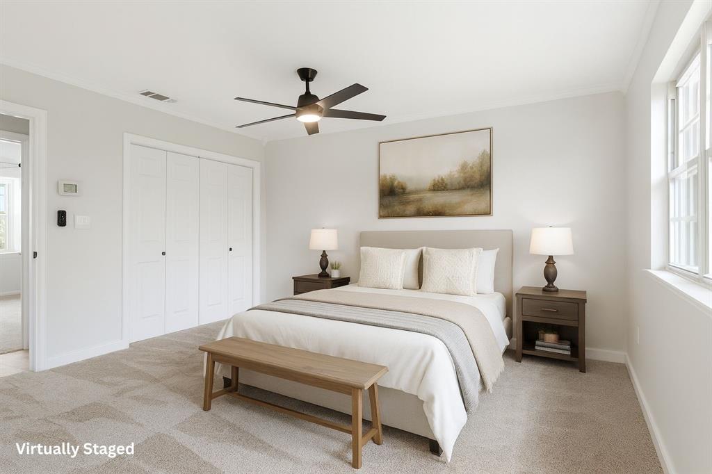 3109 Ridgedale Street Irving, TX 75062 - Photo 10 of 21 Bedroom with light colored carpet, ornamental molding, a ceiling fan, and a closet