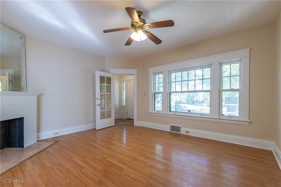 14426 Superior Road Cleveland, OH 44118 - Photo 10 of 50 Living room with light hardwood / wood-style floors, a wealth of natural light, and ceiling fan