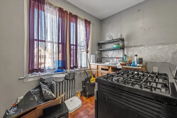 a kitchen with stainless steel appliances granite countertop a stove refrigerator and a sink