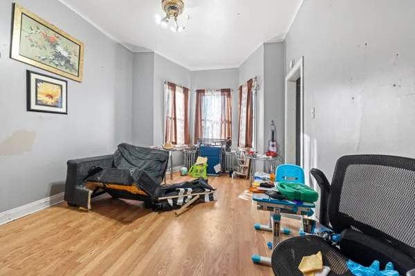 a bed room with furniture and a wooden floor