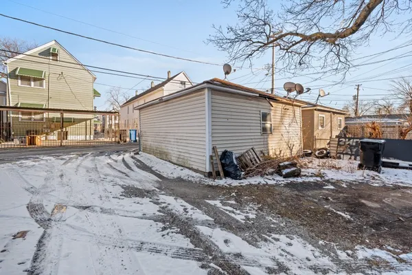 a view of a backyard with snow on the road
