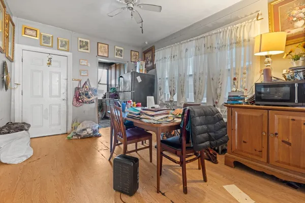 a view of a livingroom with furniture window and wooden floor