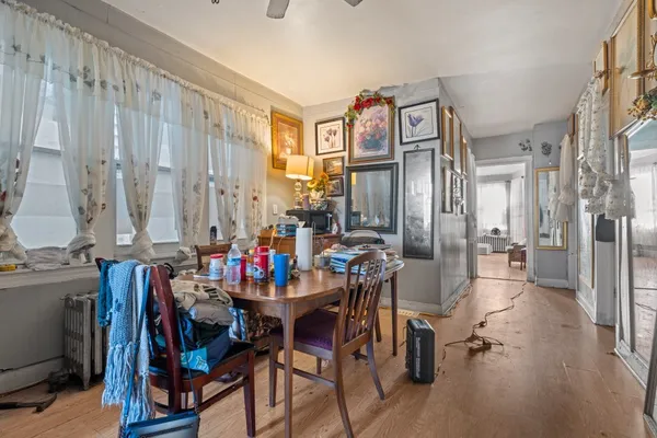 a view of a dining room with furniture and a chandelier