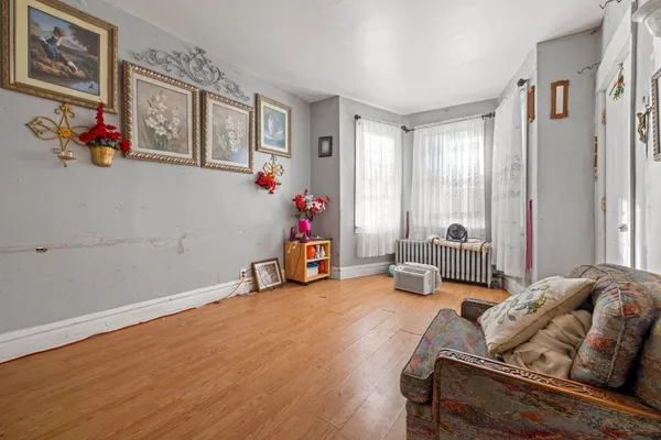 a bedroom with furniture and a large window