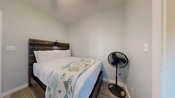 a bed sitting in a bedroom next to a window