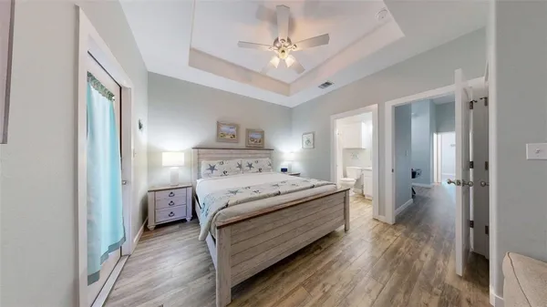 a bedroom with a bed and a chandelier