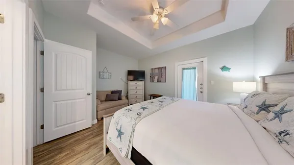 a bedroom with a bed and a chandelier