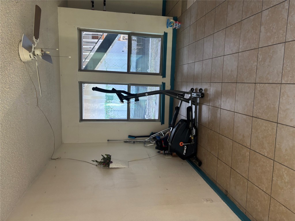 7926 Mullen Drive, Unit 1 Austin, TX 78757 - Photo 3 of 9 a room with gym equipment and a mirror