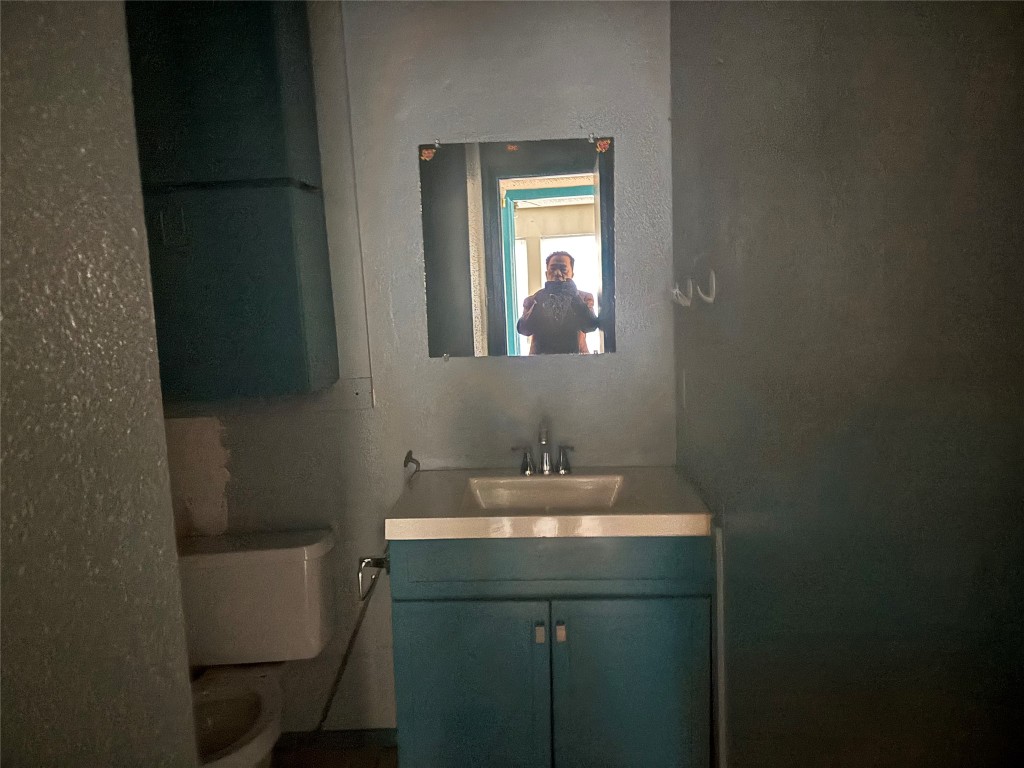 7926 Mullen Drive, Unit 1 Austin, TX 78757 - Photo 5 of 9 a bathroom with a sink toilet and mirror