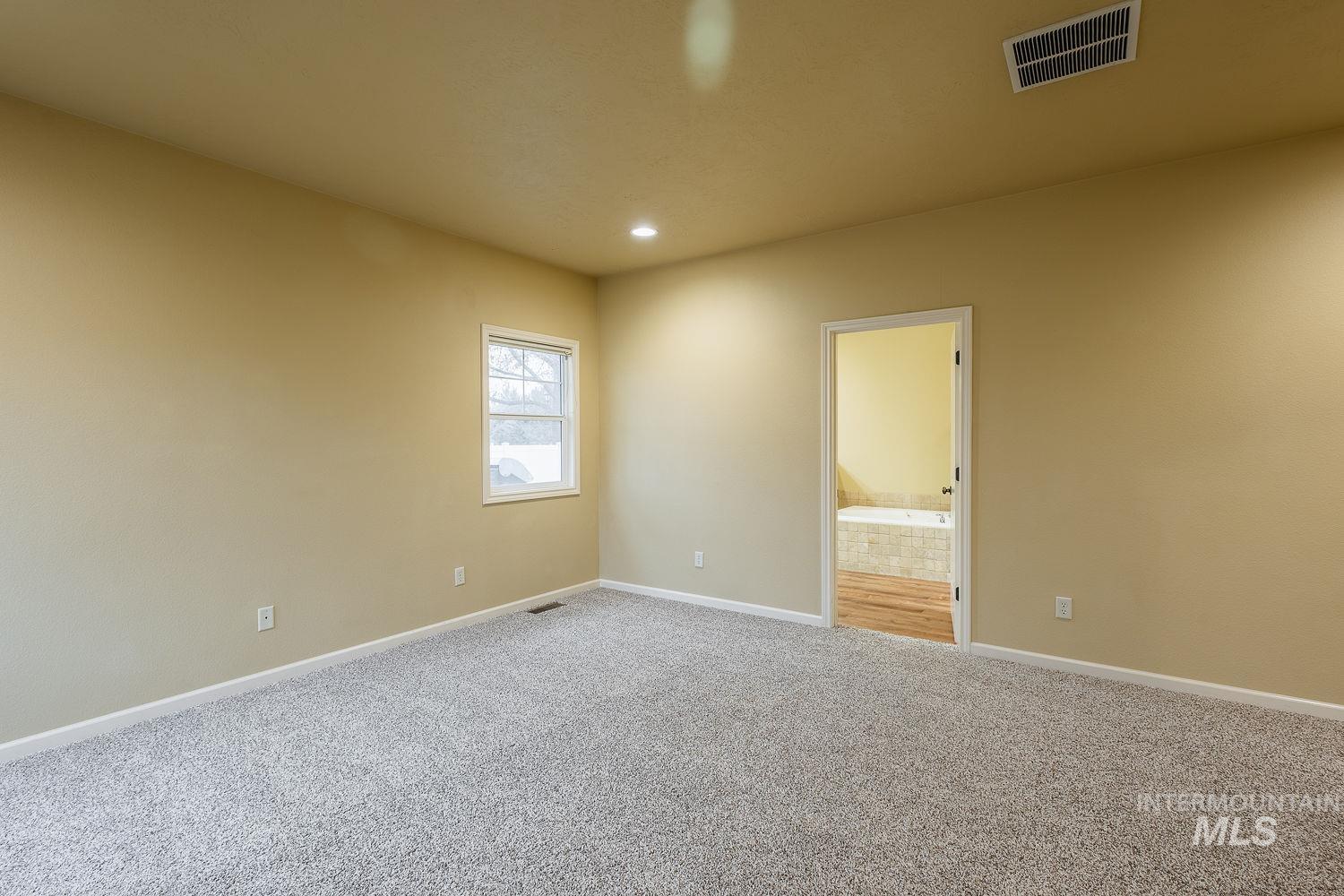215 South Spring Lake Way Star, ID 83669 - Photo 20 of 50 Carpeted spare room with baseboards and recessed lighting