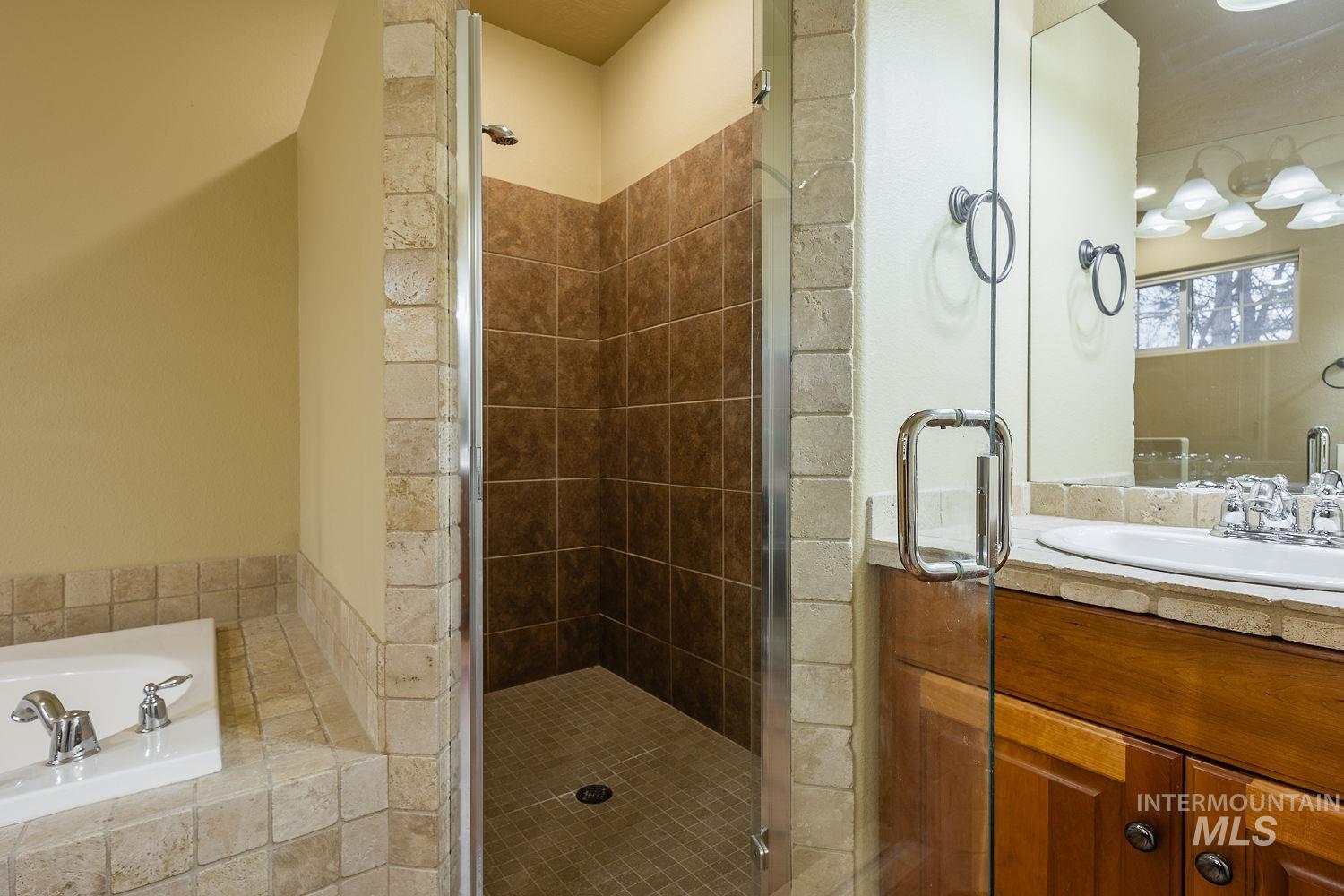 215 South Spring Lake Way Star, ID 83669 - Photo 24 of 50 Full bath featuring vanity, a bath, and a shower stall
