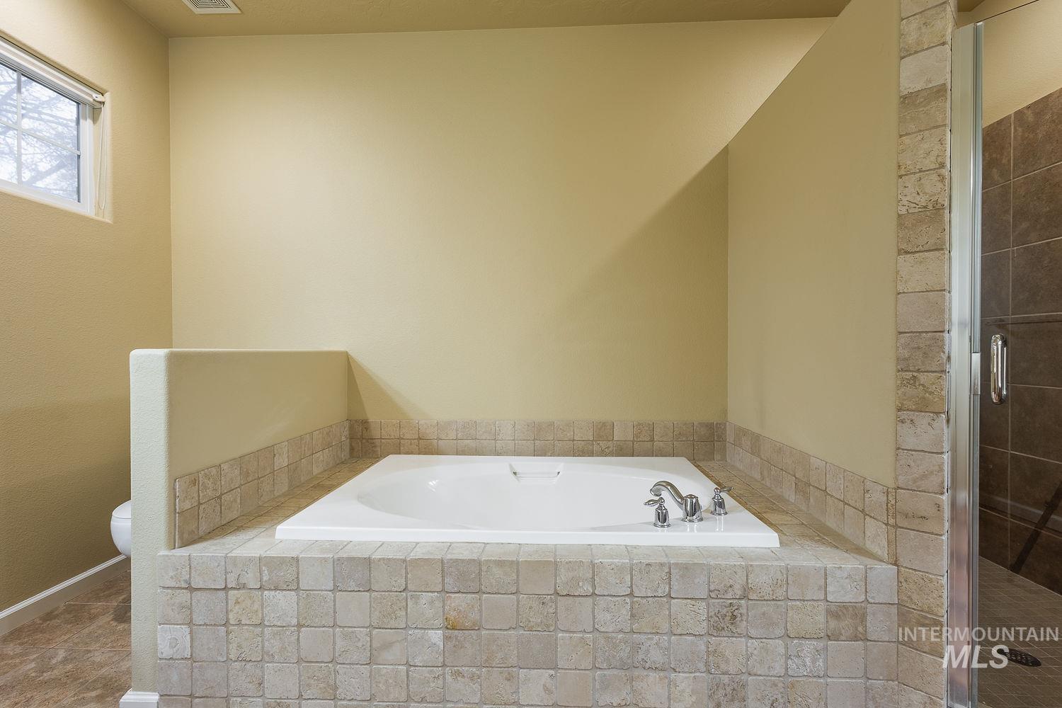 215 South Spring Lake Way Star, ID 83669 - Photo 25 of 50 Full bathroom with a bath and a shower stall