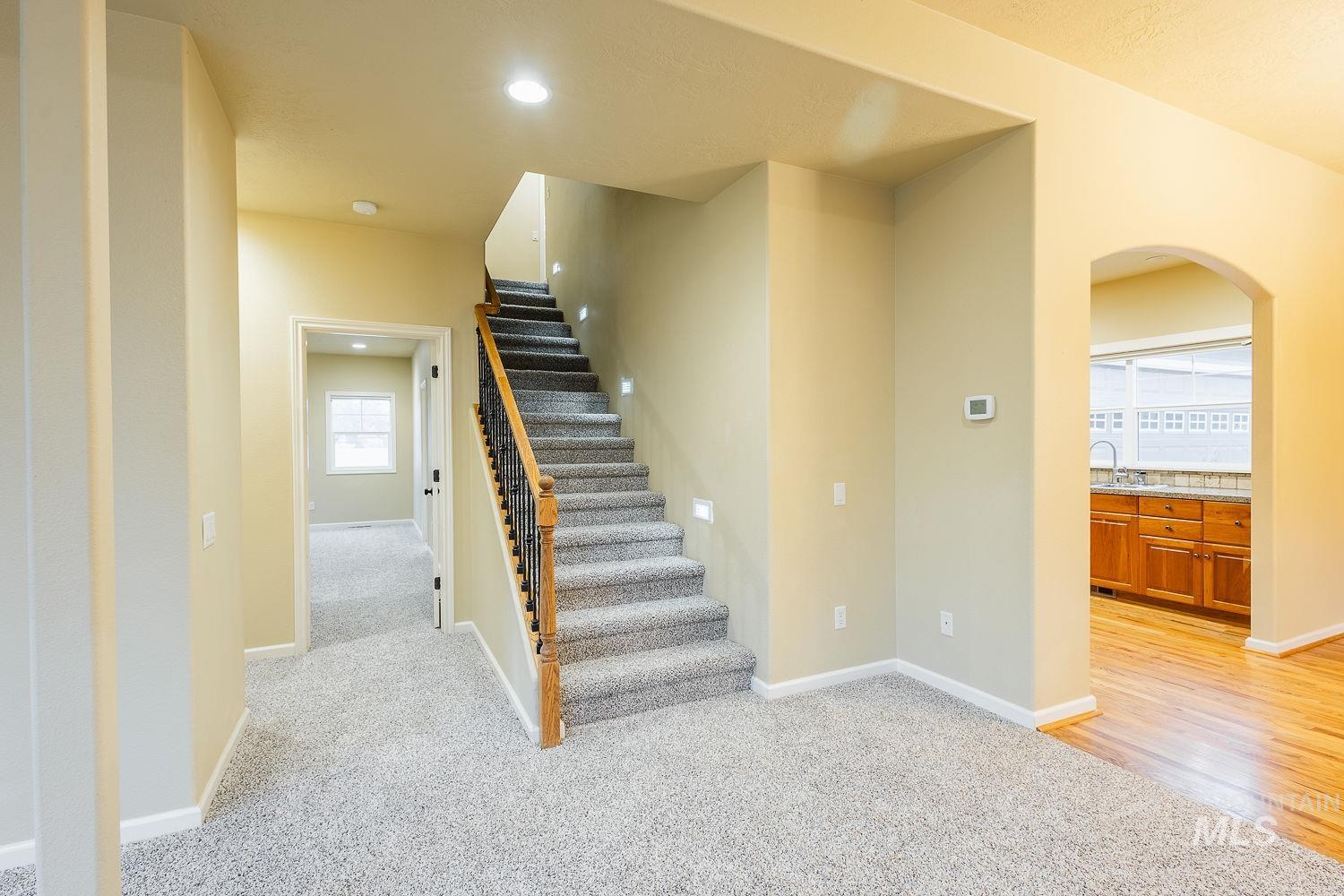 215 South Spring Lake Way Star, ID 83669 - Photo 26 of 50 Stairway with arched walkways, carpet floors, and recessed lighting