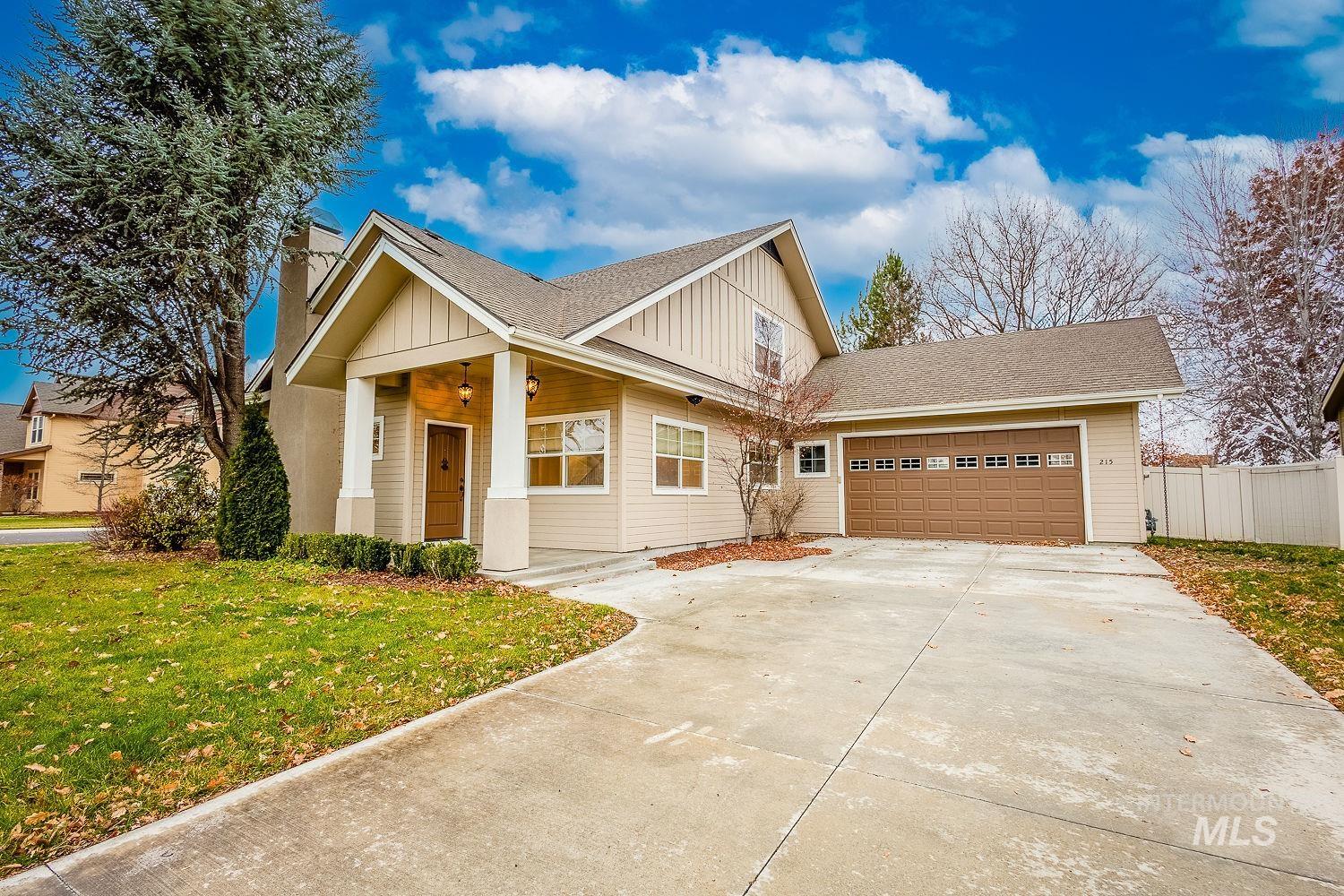 215 South Spring Lake Way Star, ID 83669 - Photo 4 of 50 Craftsman house with board and batten siding, roof with shingles, driveway, an attached garage, and a porch