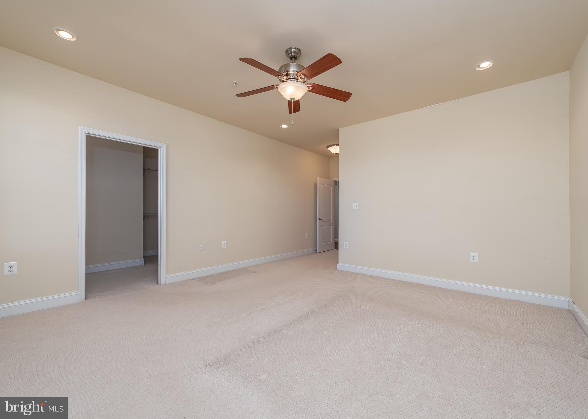 7662 Maple Lawn Boulevard, Unit 26 Fulton, MD 20759 - Photo 13 of 37 an empty room with a ceiling fan and a bathroom