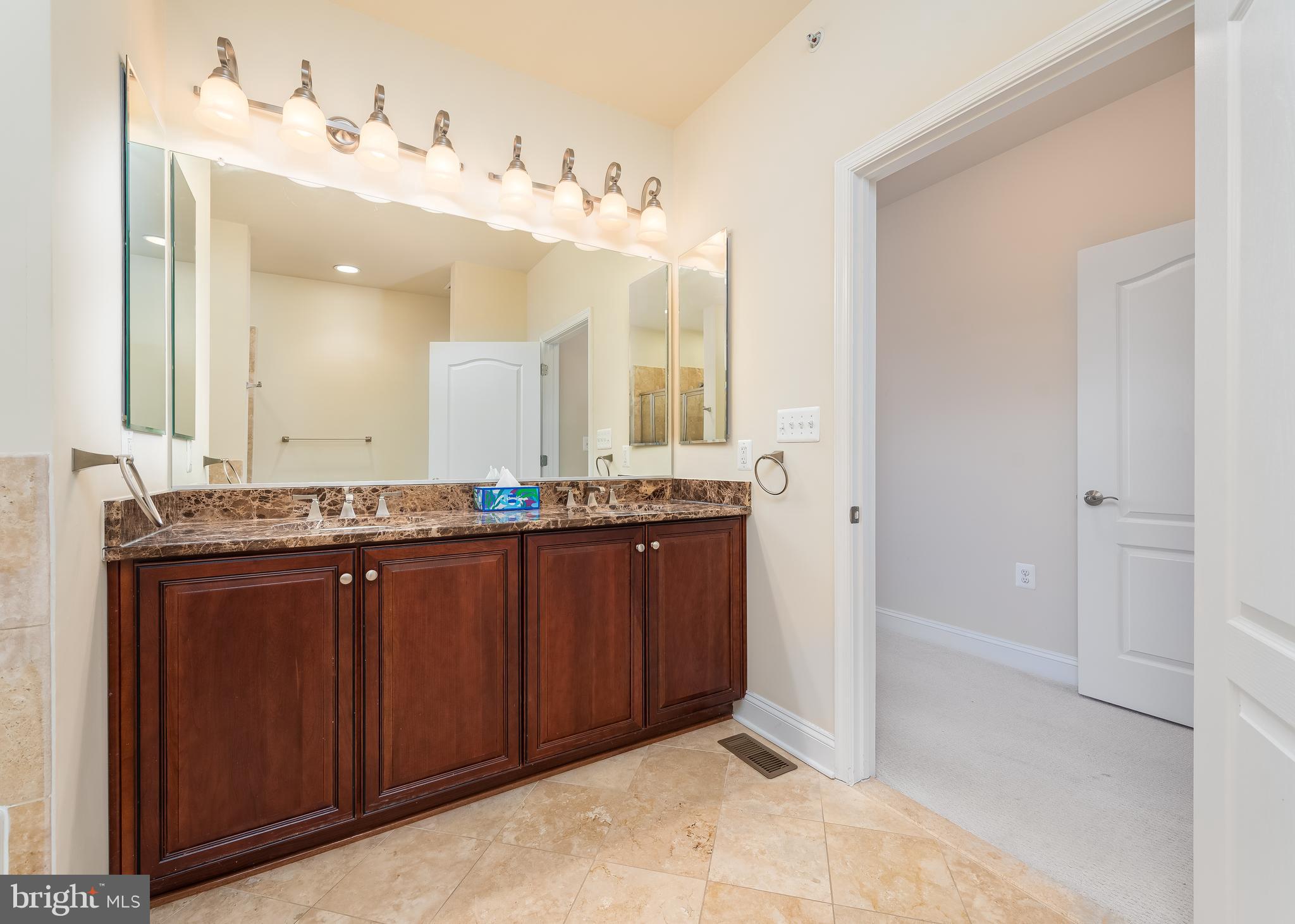 7662 Maple Lawn Boulevard, Unit 26 Fulton, MD 20759 - Photo 16 of 37 a bathroom with a granite countertop sink and a mirror