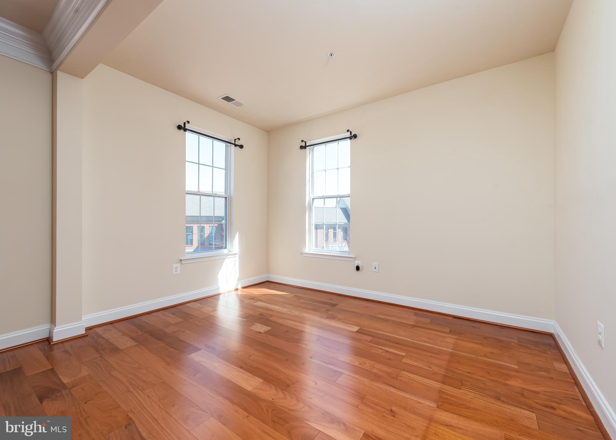 7662 Maple Lawn Boulevard, Unit 26 Fulton, MD 20759 - Photo 20 of 37 an empty room with wooden floor and windows