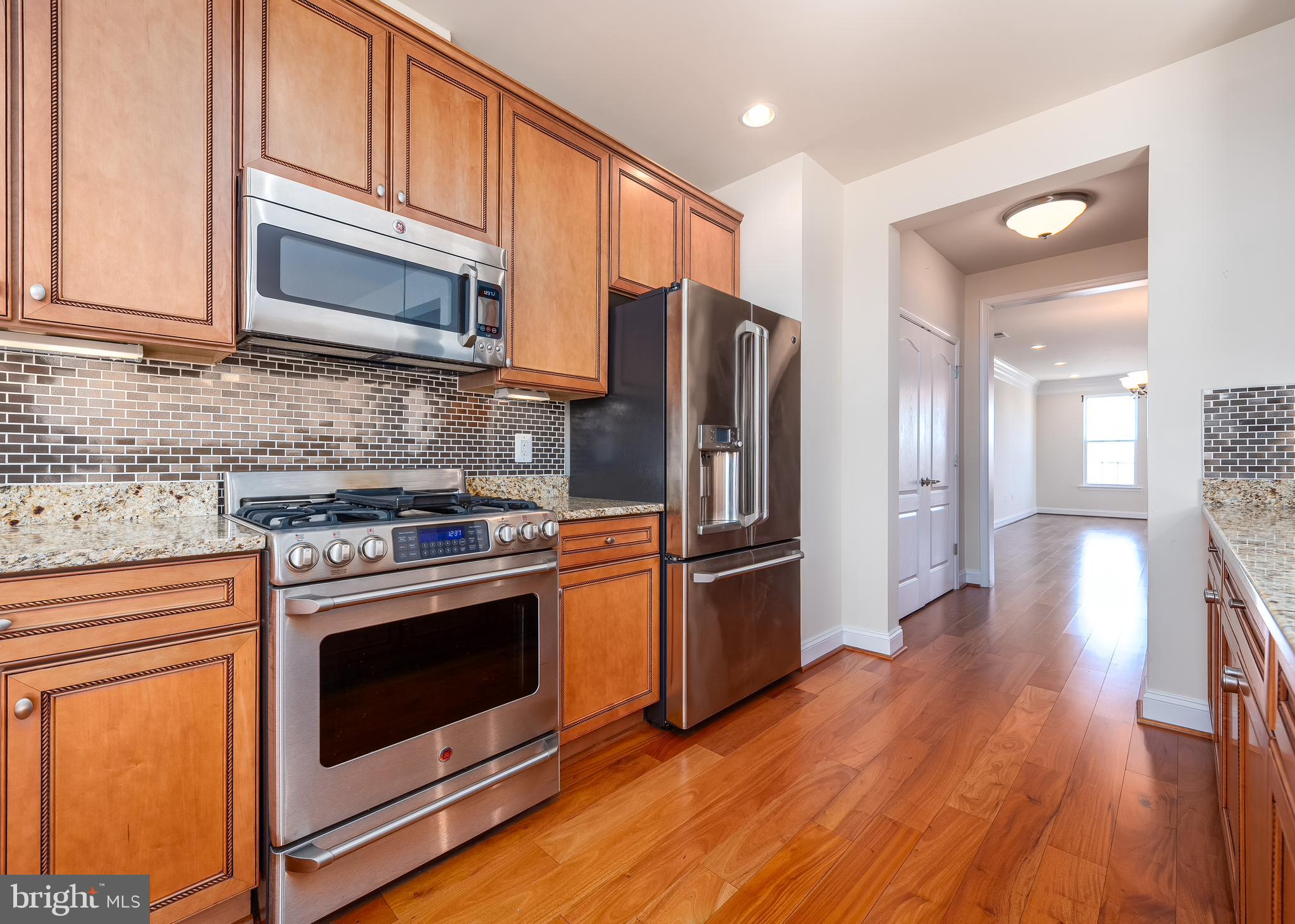 7662 Maple Lawn Boulevard, Unit 26 Fulton, MD 20759 - Photo 2 of 37 a kitchen with stainless steel appliances granite countertop a refrigerator stove and sink