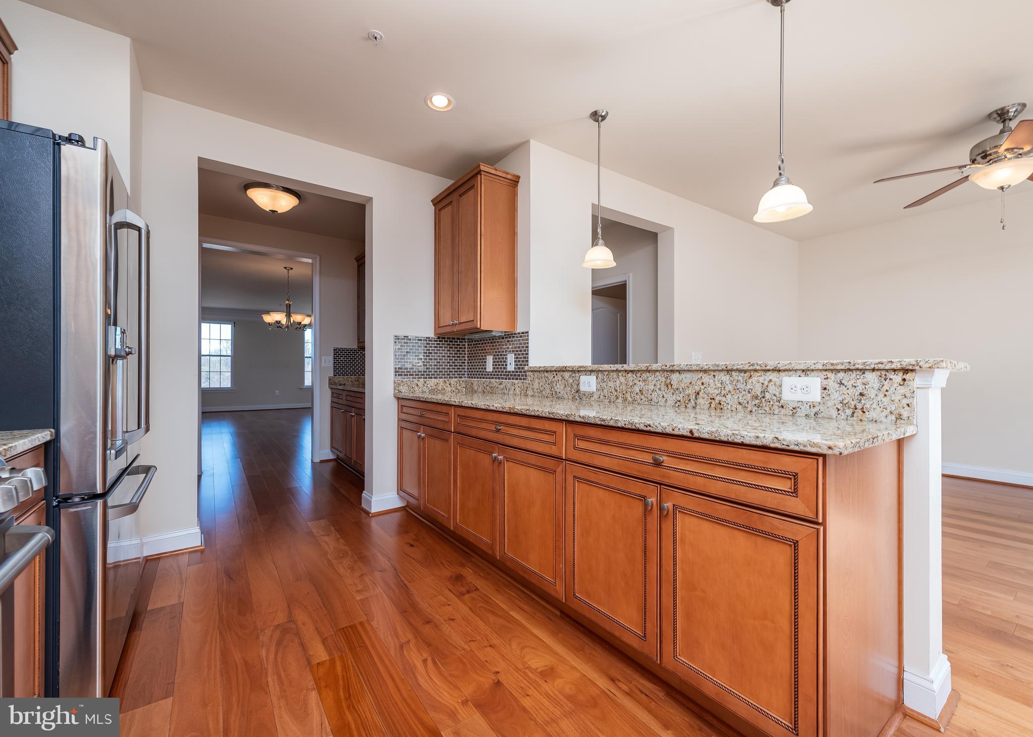 7662 Maple Lawn Boulevard, Unit 26 Fulton, MD 20759 - Photo 4 of 37 a view of a kitchen with a sink and wooden floor