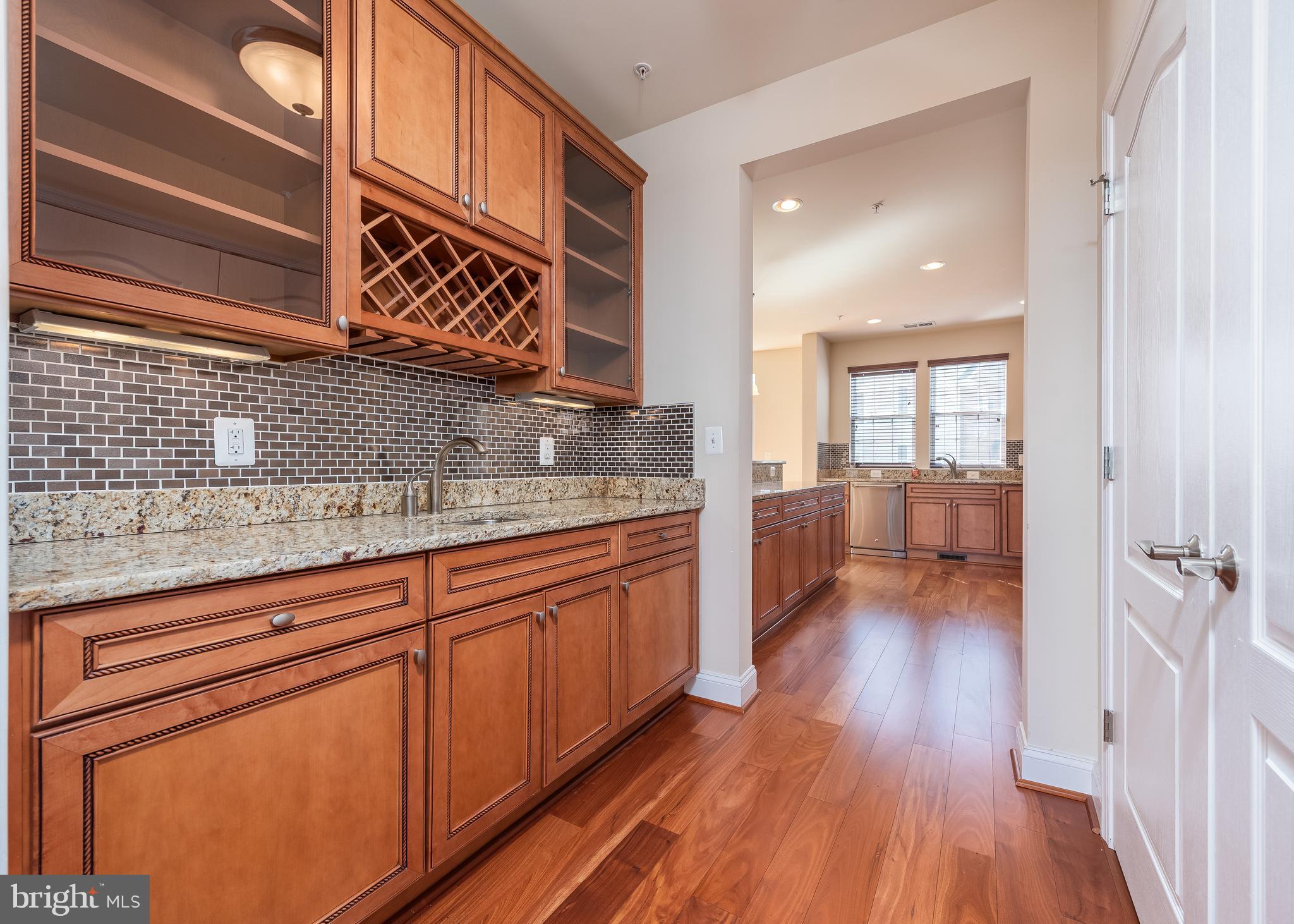 7662 Maple Lawn Boulevard, Unit 26 Fulton, MD 20759 - Photo 6 of 37 a kitchen with granite countertop a sink cabinets and wooden floor