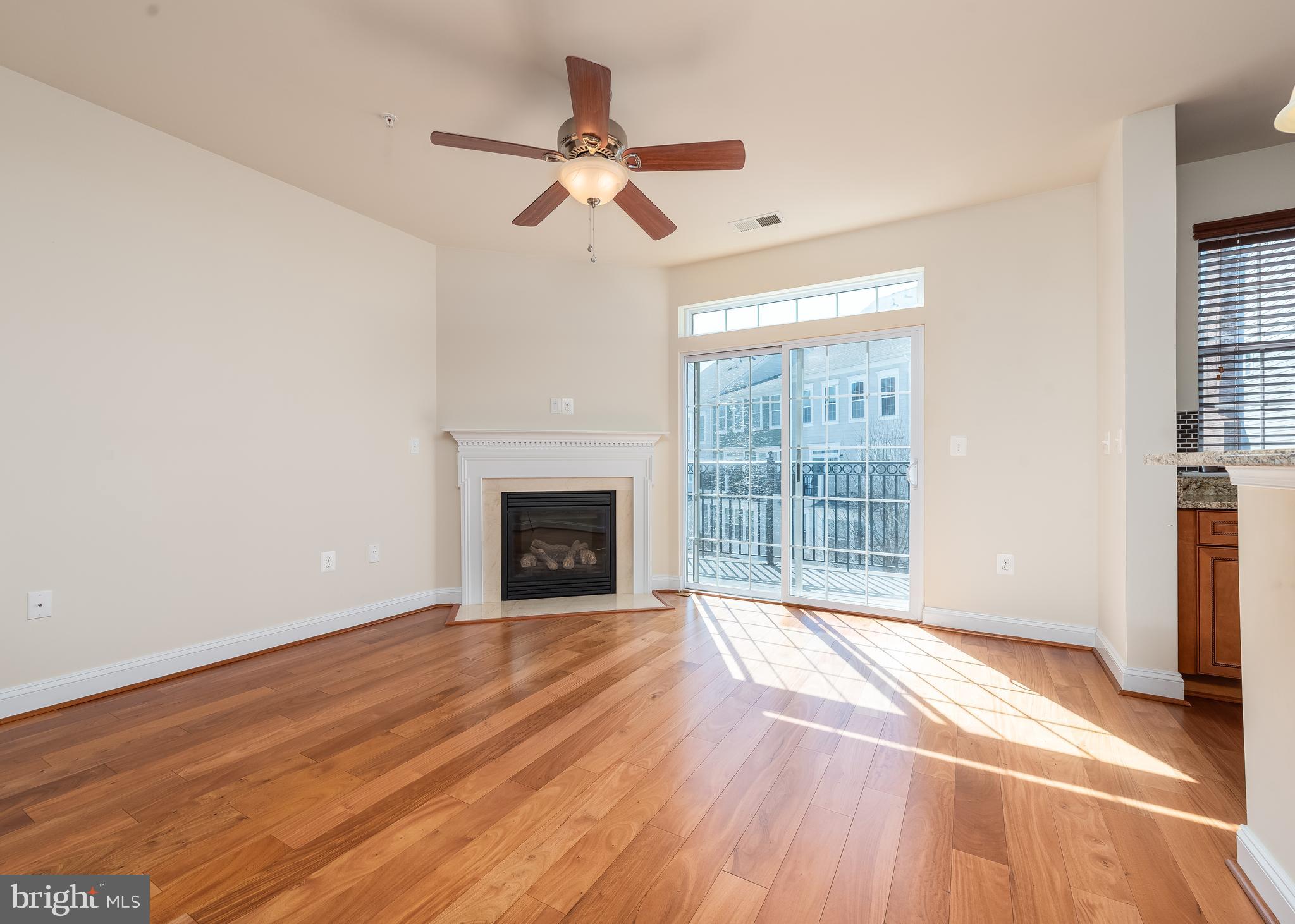 7662 Maple Lawn Boulevard, Unit 26 Fulton, MD 20759 - Photo 10 of 37 a view of empty room with wooden floor and fan