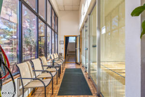 5829 East Buck Springs Road, Unit 140 Pinetop, AZ 85935 - Photo 16 of 37 a view of a balcony with furniture and floor to ceiling window