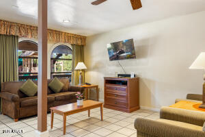 5829 East Buck Springs Road, Unit 140 Pinetop, AZ 85935 - Photo 22 of 37 a living room with furniture and a flat screen tv