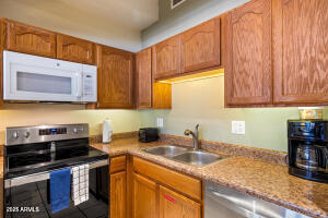 5829 East Buck Springs Road, Unit 140 Pinetop, AZ 85935 - Photo 27 of 37 a kitchen with stainless steel appliances granite countertop a sink stove and cabinets