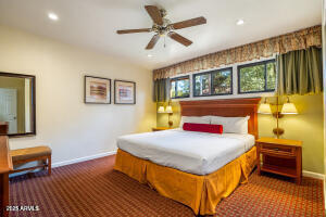 5829 East Buck Springs Road, Unit 140 Pinetop, AZ 85935 - Photo 28 of 37 a bedroom with a bed and wooden floor