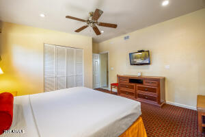 5829 East Buck Springs Road, Unit 140 Pinetop, AZ 85935 - Photo 29 of 37 a bedroom with a bed and a flat screen tv