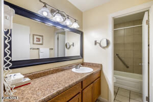 5829 East Buck Springs Road, Unit 140 Pinetop, AZ 85935 - Photo 31 of 37 a bathroom with a granite countertop sink and a mirror