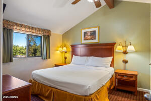 5829 East Buck Springs Road, Unit 140 Pinetop, AZ 85935 - Photo 35 of 37 a bedroom with a bed and a dresser