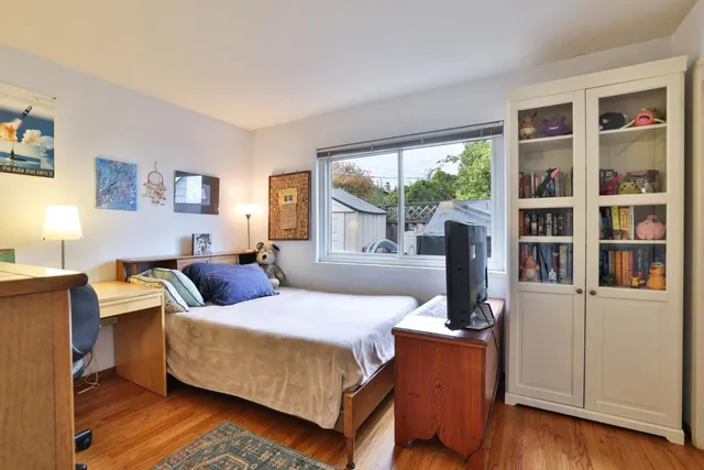 a bedroom with a large bed and a large window