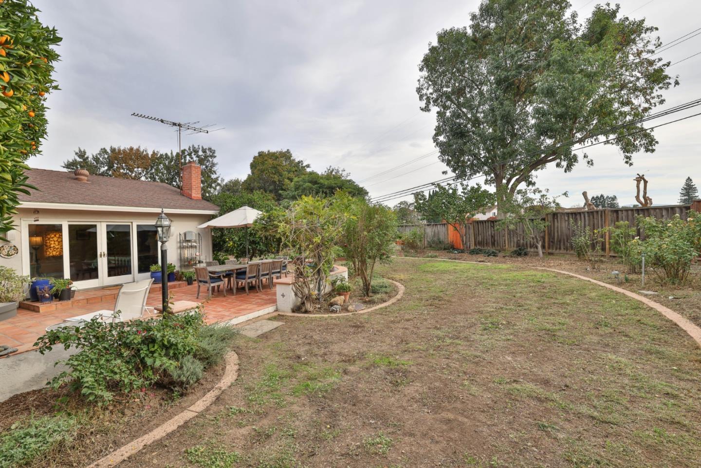 3772 Thrush Way Santa Clara, CA 95051 - Photo 16 of 21 a view of a backyard with table and chairs under an umbrella