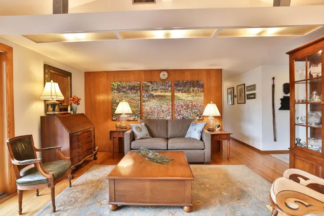 a living room with furniture a rug and a large window