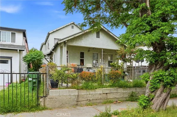 a front view of a house with plants