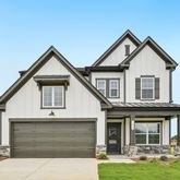 a front view of a house with yard and garage