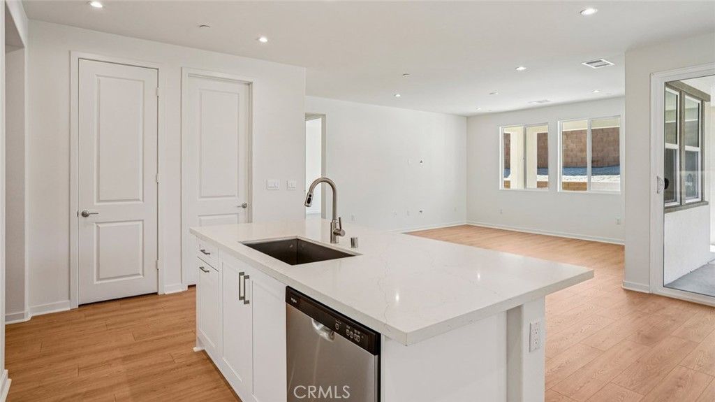 73578 Raphael Drive Palm Desert, CA 92211 - Photo 11 of 33 a kitchen that has a sink a stove and wooden floor