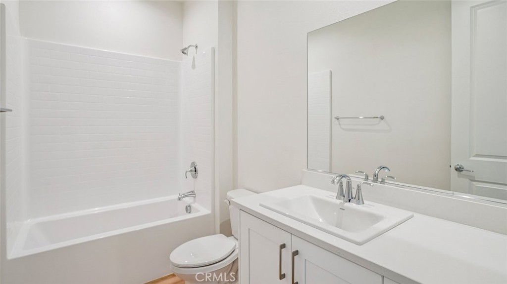 73578 Raphael Drive Palm Desert, CA 92211 - Photo 19 of 33 a bathroom with a granite countertop sink toilet and shower