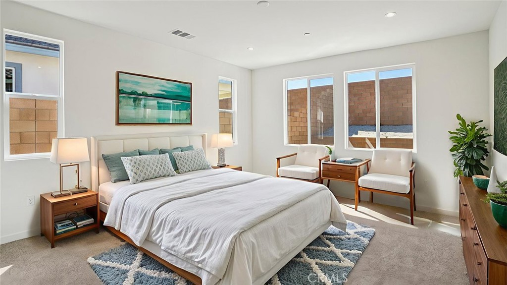 73578 Raphael Drive Palm Desert, CA 92211 - Photo 21 of 33 a bedroom with bed and a potted plant