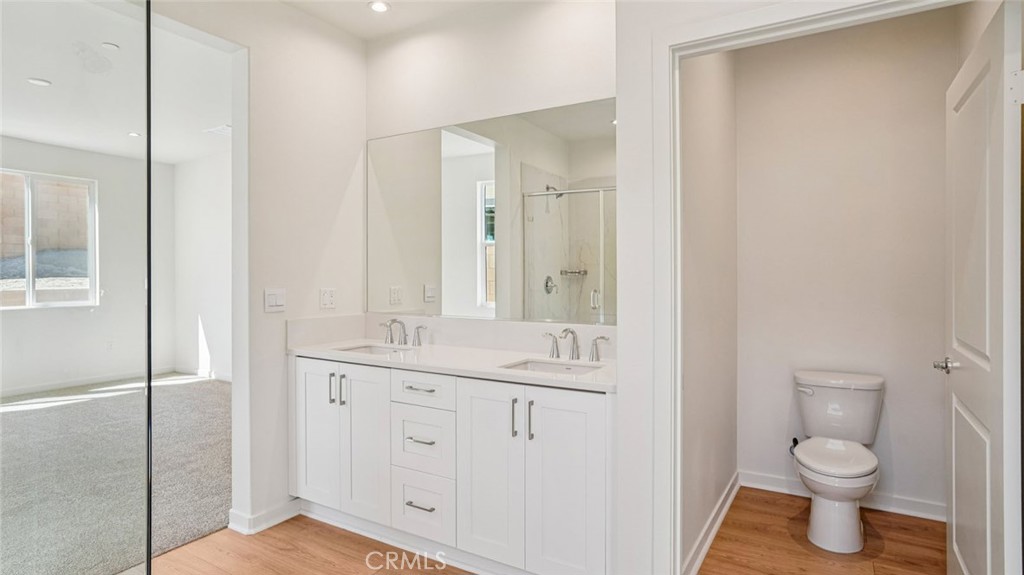 73578 Raphael Drive Palm Desert, CA 92211 - Photo 26 of 33 a bathroom with a granite countertop sink a toilet and a shower