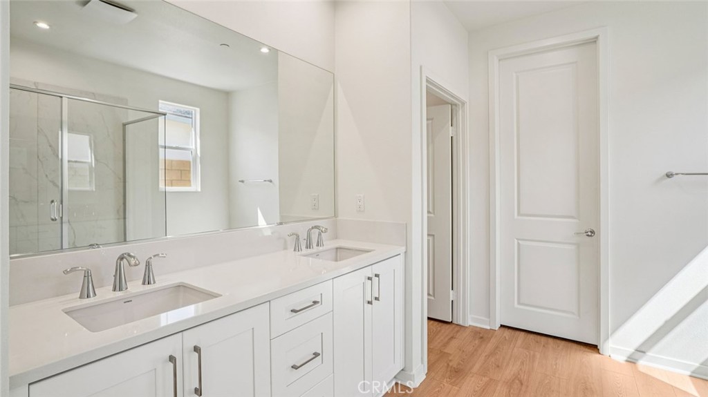 73578 Raphael Drive Palm Desert, CA 92211 - Photo 27 of 33 a bathroom with a double vanity sink and mirror